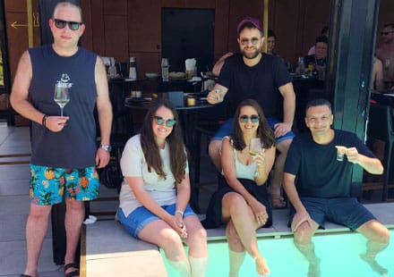 ClickEat team members enjoying drinks by the pool